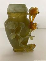 Overview of carved yellow-green jade vase with flower branch