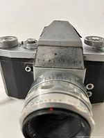 Front view showing Praktica IV branding and attached Tessar lens
