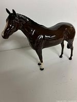 Left side view of brown porcelain horse