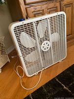 Front view of white Airworks box fan showing grille and blades