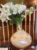 Full view of artificial floral arrangement and vase