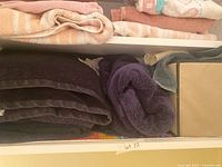 Shelved folded towels and storage bin