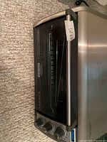 Angled view of entire toaster oven showing stainless steel body and control knobs