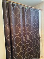 Front view of brown shower curtain with taupe geometric lattice pattern
