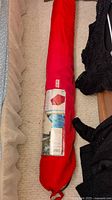 Umbrella packed in red carrying bag