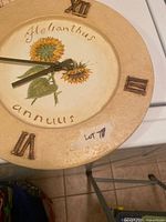 Round sunflower wall clock close-up showing design and Roman numerals