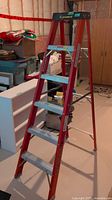 Full view of Featherlite red fiberglass step ladder