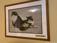 framed print showing two cats in wooden frame with mat