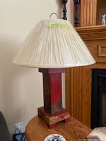 Full view of lamp with shade on wooden surface