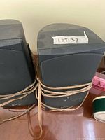 Front view of both Infinity speakers showing grilles and logo