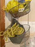 full view of three-tier hanging wire baskets with rope inside