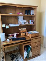 Full view of oak desk with hutch showing shelves, keyboard tray, drawers, contents not included