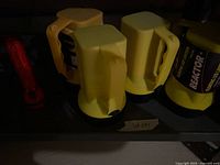 Shelf with four yellow Reactor lanterns and one red flashlight