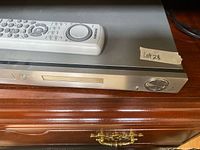 Front view of Samsung DVD player with remote resting on top