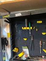 Close-up of pegboard with hand tools