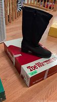 Boot standing on branded Toe Warmers box