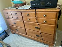 Front view of dresser showing all drawers and hardware