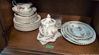 Entire set inside cabinet showing plates, gravy boat, sugar bowl