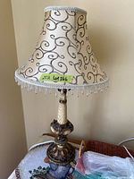Full view of lamp unlit showing shade pattern, bead fringe, ornate base