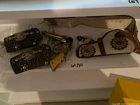 Overall view of cap gun, cuffs, holster and belt inside shelf