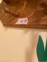 wooden peg rack corner closeup with Lot sticker