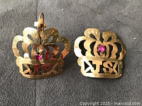 Front view showing crown shapes, pink stones, JS cut-out