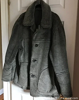 Front view of gray faux fur jacket coat showing collar, pockets and missing buttons