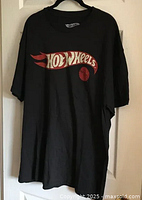 Front view of black Hot Wheels t-shirt showing logo
