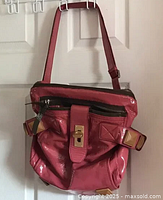 Full view of dusty rose patent leather shoulder bag hanging