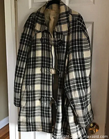 Full view of plaid jacket hanging on door