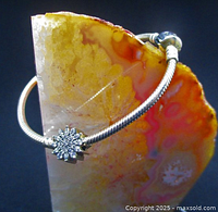 Bracelet front view on agate slab showing snowflake charm