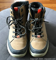 Front view of both boots showing laces, toe guards and branding tag