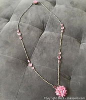 Full view of necklace showing chain, beads and pendant