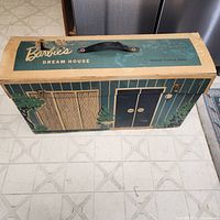 Top view showing Barbie’s Dream House logo, handle, overall color