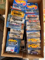 Top view of box showing multiple sealed Hot Wheels cards