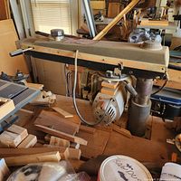 Side view of radial arm saw mounted on bench showing motor housing and arm