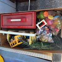 Overview of lot in box: hospital roof, school bus, bag of accessories, green grass