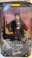 Front view of boxed Harley-Davidson Barbie wearing cap, leather jacket, jeans