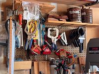 Pegboard with various clamps and accessories visible