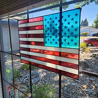 Stained-glass American flag hanging panel displayed in window
