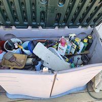 Overall view of open storage chest showing lid and front doors with contents