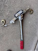 Steel ratchet puller showing hooks, cable and handle