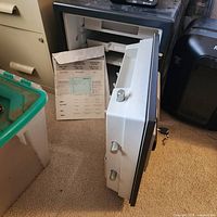 Safe with door open showing interior tray and drawer