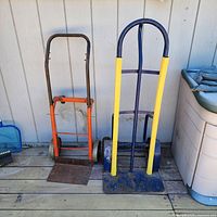 Both hand trucks standing side-by-side on deck
