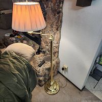 Lamp beside couch showing overall height, swing arm and shade