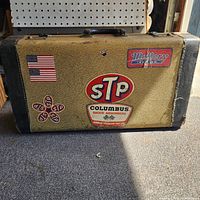 Front of tan crackle finish trumpet case with STP, Mallory and USA flag decals