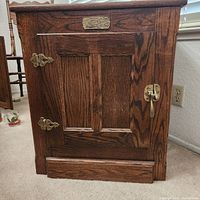 Front view of oak ice box cabinet showing overall design