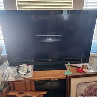 Front view of 47" Vizio LCD TV powered on displaying 'No Signal' message