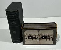 Box holding 50 Keystone Selected Subjects stereoview cards with several cards fanned out showing front image.