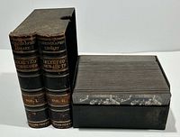 Two black volumes titled 'Selected Subjects Vol. I' and 'Vol. II' next to a box filled with stacked stereoview cards.